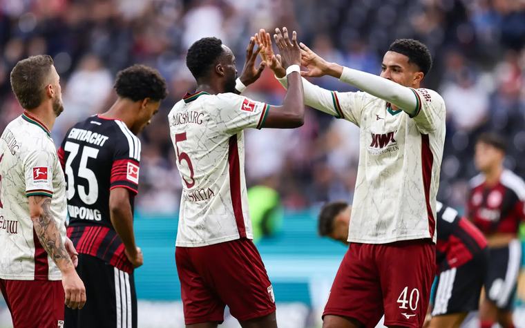 Minnows Augsburg sink Frankfurt to top Bundesliga table